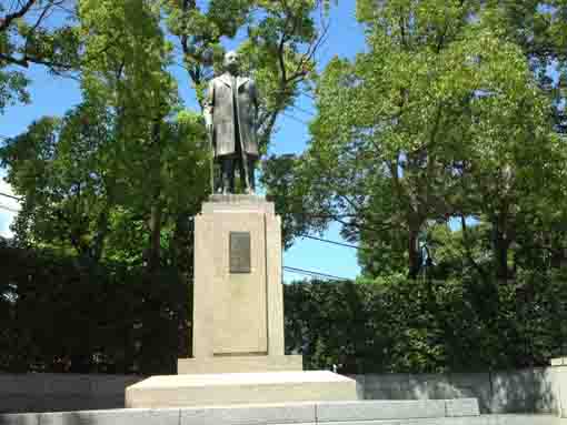 the statue of Gen Tanaka in green woods